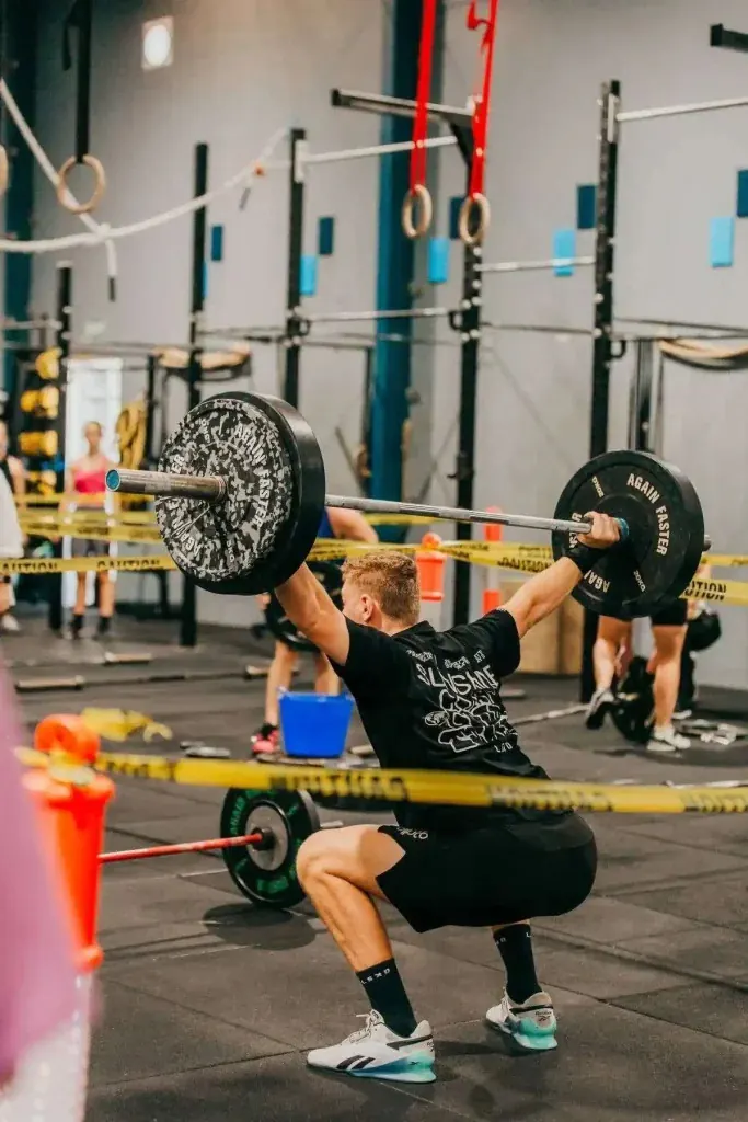 Coach guiding a member through functional training at CrossFit Movida on the Sunshine Coast